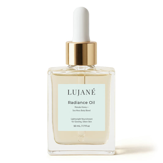 LUJANÉ Radiance Oil in a premium glass dropper bottle, featuring a potent Manuka Honey and Sea Moss body blend designed to provide lightweight nourishment for glowing, silken skin.