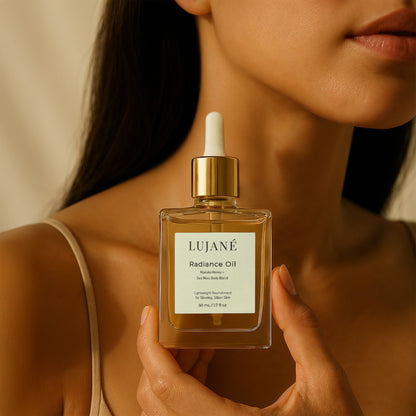 LUJANÉ Radiance Oil held in a luxury lifestyle setting; a potent Manuka Honey and Sea Moss body blend designed to provide lightweight nourishment for glowing, silken skin.