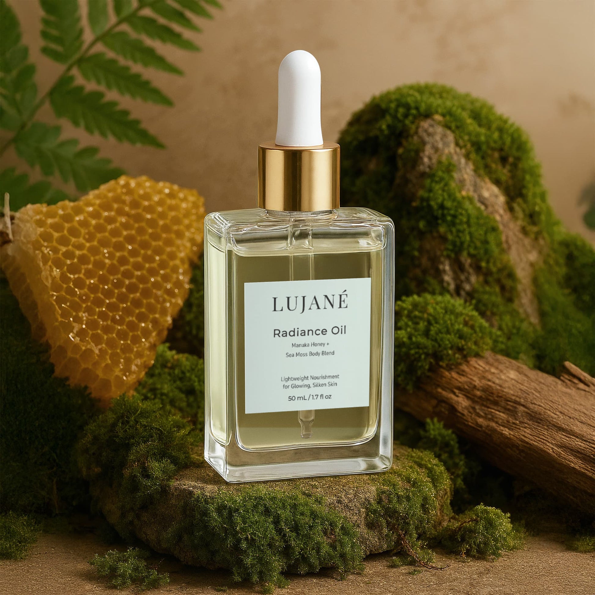 LUJANÉ Radiance Oil showcased with a natural honeycomb and forest moss; a luxury superfood body oil featuring Manuka Honey and Sea Moss to reveal glowing, silken skin.