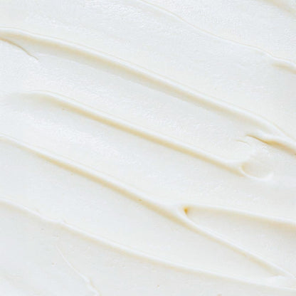 A macro close-up showing the rich, creamy, and whipped texture of LUJANÉ Renewal Balm, highlighting the smooth consistency of grass-fed tallow for deep skin nourishment.
